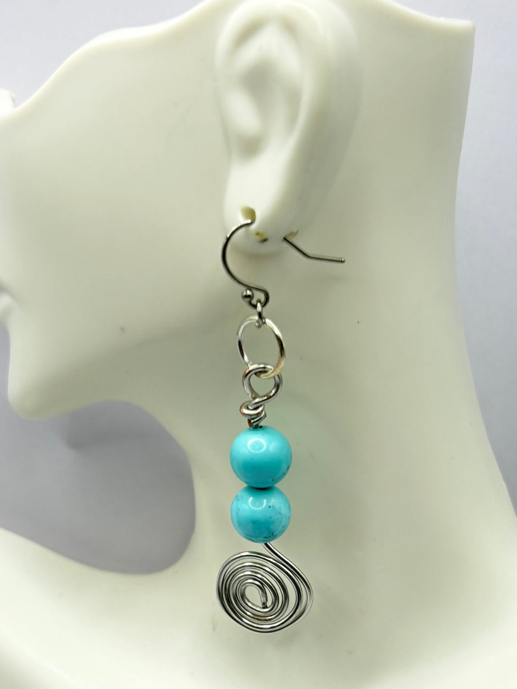 Spiral earring with blue bead